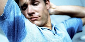 Man looking at sweat under his arms